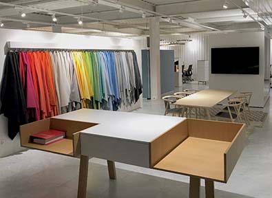 Designer desk with multiple colored fabrics hanging